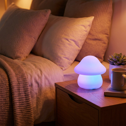 Glow Buddy silicone mushroom night light glowing on a bedroom nightstand